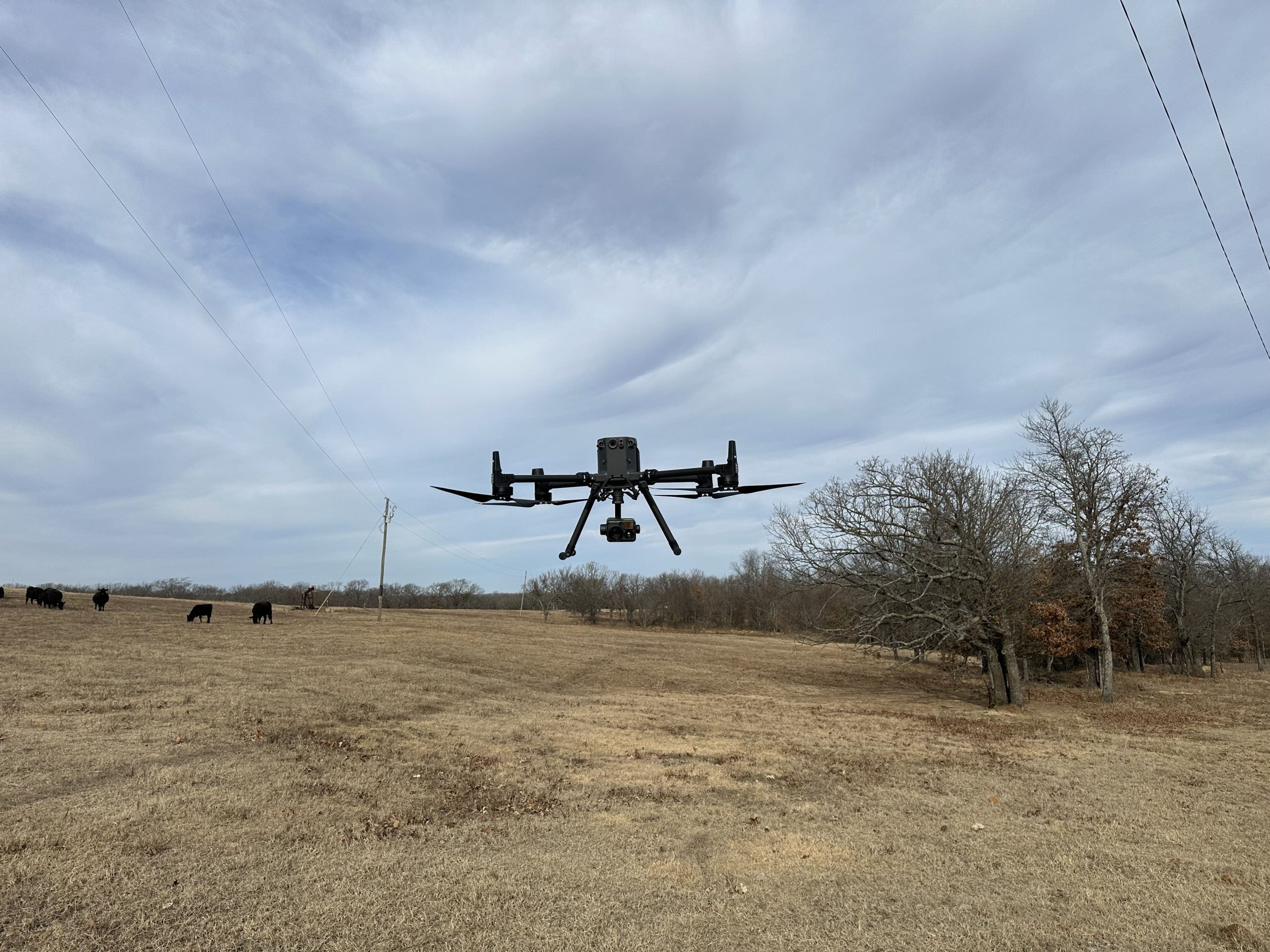 Drone flying over electric utility infrastructure