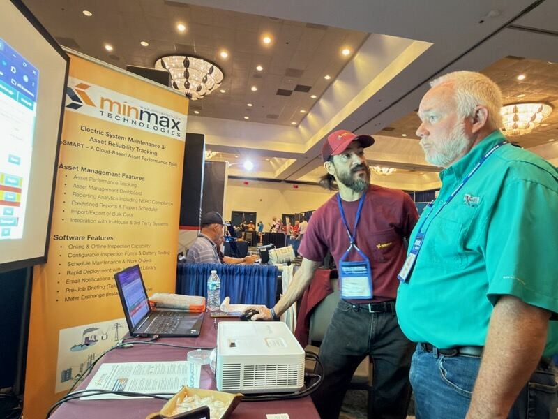 A MinMax team member walks an attendee through a demo at the MinMax booth at the 2026 North Carolina Meter School